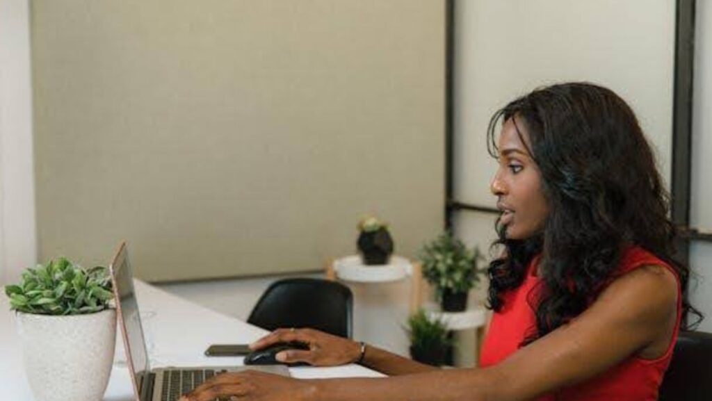 A woman using a laptop in her office