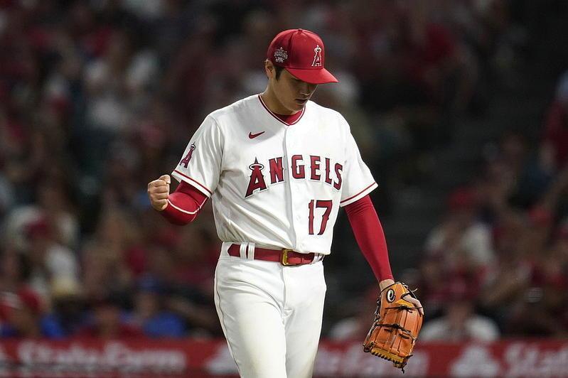 Shohei Ohtani during a baseball game, with spectator stands in the background.